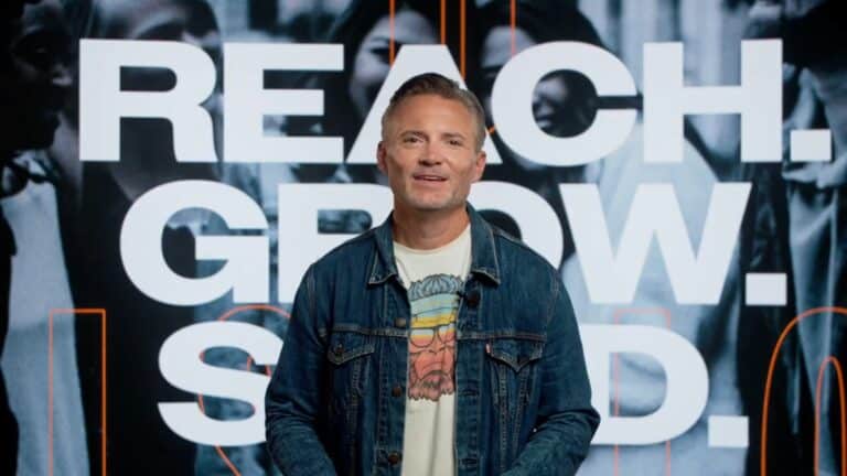 Person standing in front of text.